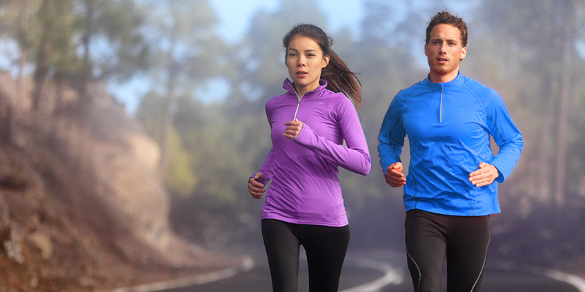 Woman Wearing Sportswear Exercising Outside during Winter Stock